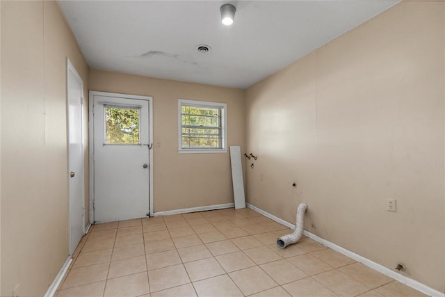 laundry area featuring light tile patterned flooring and hookup for an electric dryer