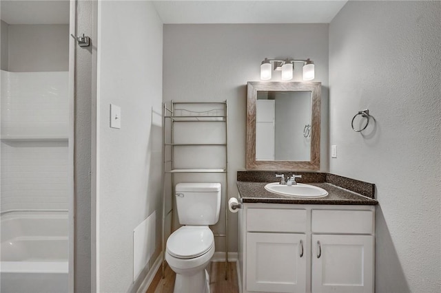 bathroom featuring wood finished floors, vanity, and toilet