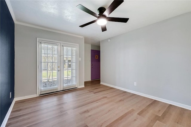 unfurnished room featuring light wood-type flooring, baseboards, crown molding, and french doors