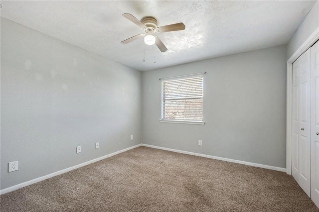 unfurnished bedroom with a ceiling fan, a closet, carpet flooring, and baseboards