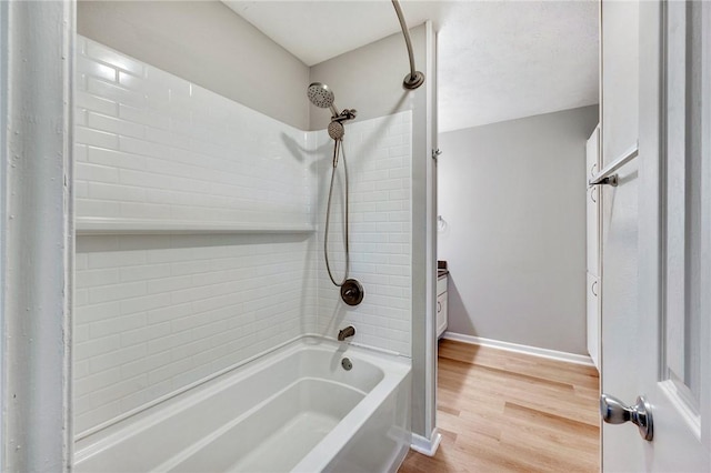 full bathroom with shower / tub combination, baseboards, and wood finished floors