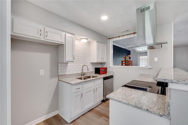 kitchen with island range hood, white cabinets, light wood-style flooring, a sink, and stainless steel dishwasher