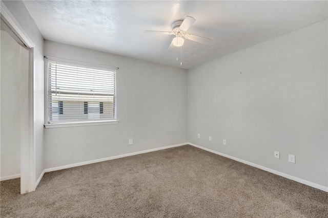 unfurnished room featuring baseboards, a ceiling fan, and carpet flooring