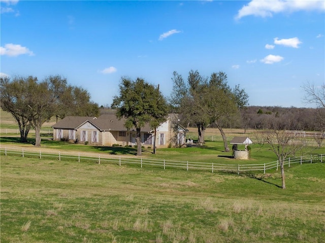 view of yard with a rural view and fence