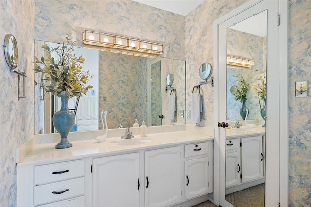 bathroom featuring wallpapered walls and vanity