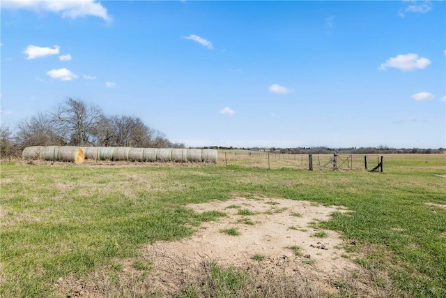 view of yard featuring a rural view and fence