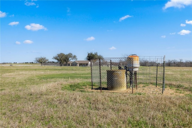 view of yard featuring a rural view and fence