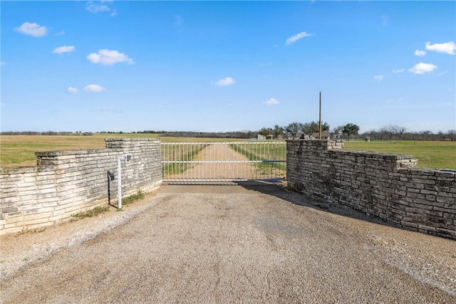 view of gate featuring a rural view