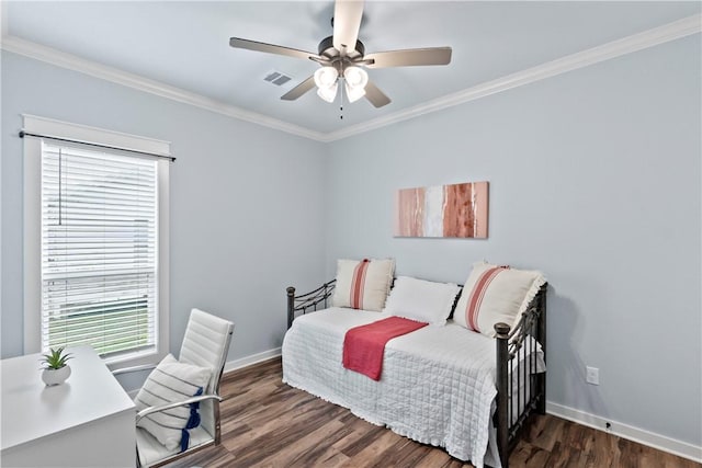 bedroom featuring baseboards, wood finished floors, and multiple windows