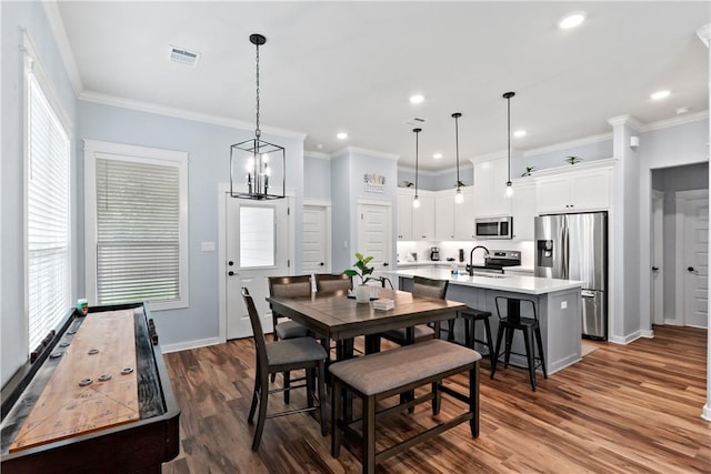 dining space featuring visible vents, baseboards, dark wood-type flooring, and a healthy amount of sunlight