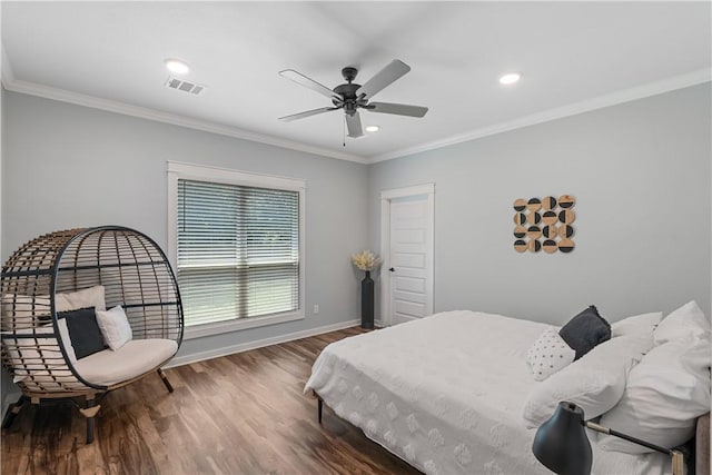 2607 Southside Dr, Bryan, TX 77803 - bedroom featuring baseboards, crown molding, visible vents, and wood finished floors