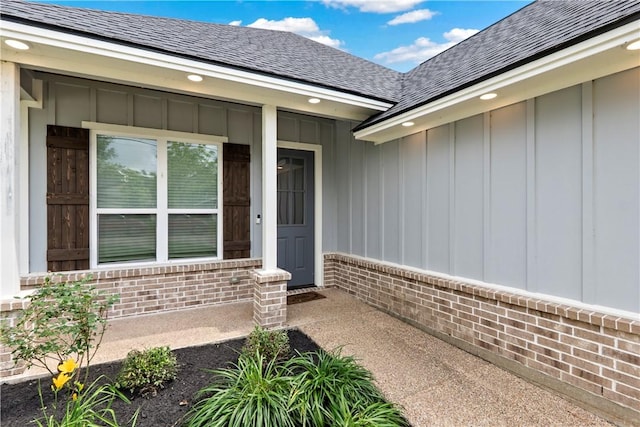 2607 Southside Dr, Bryan, TX 77803 - entrance to property with roof with shingles, brick siding, and board and batten siding