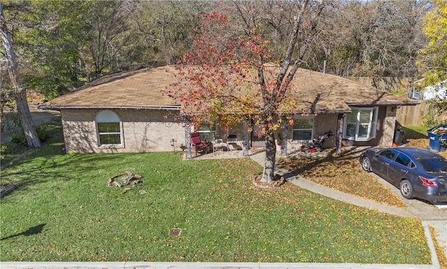 ranch-style home featuring a front yard and a patio