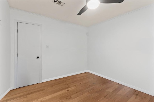 unfurnished room with ceiling fan, ornamental molding, and light wood-type flooring