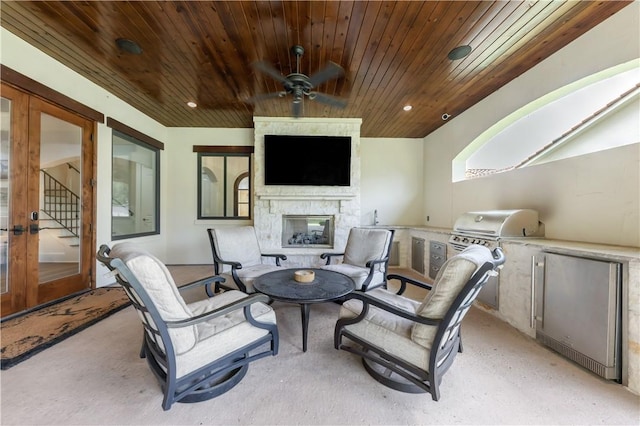 4231 Villaggio Ct, Bryan, TX 77802 - view of patio with an outdoor stone fireplace, area for grilling, a ceiling fan, and french doors