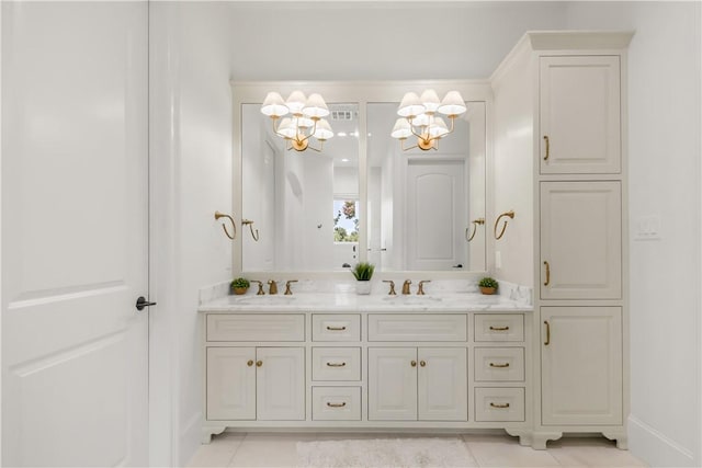 4231 Villaggio Ct, Bryan, TX 77802 - full bath featuring a chandelier, double vanity, and tile patterned floors