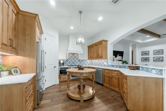 4231 Villaggio Ct, Bryan, TX 77802 - kitchen featuring stainless steel appliances, a peninsula, tasteful backsplash, light countertops, and dark wood finished floors