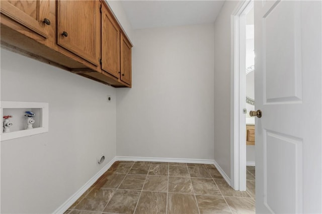 clothes washing area with baseboards, hookup for a washing machine, cabinet space, and hookup for an electric dryer