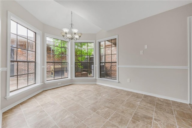 unfurnished dining area featuring an inviting chandelier, baseboards, and lofted ceiling