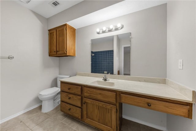 bathroom featuring a tile shower, vanity, toilet, tile patterned floors, and visible vents
