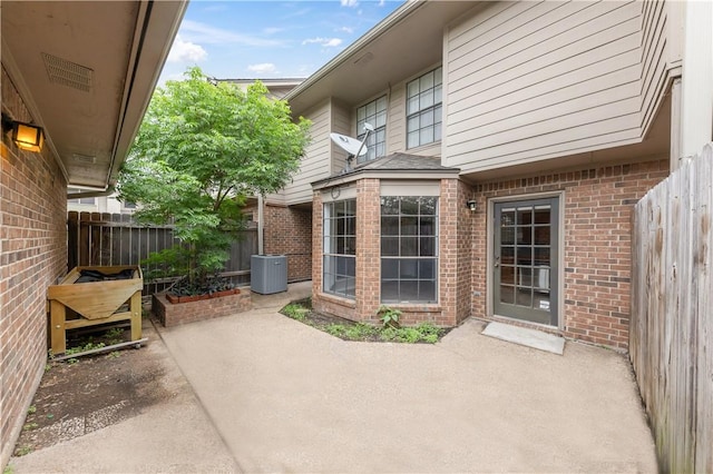 view of patio with central AC and fence
