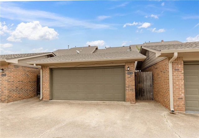 exterior space with brick siding and driveway