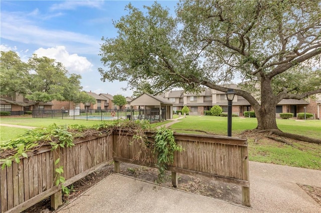 view of patio featuring a residential view and fence