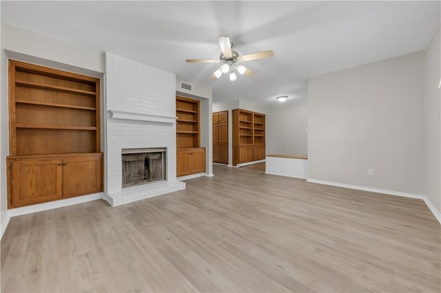 unfurnished living room with visible vents, a fireplace, baseboards, ceiling fan, and light wood-style flooring