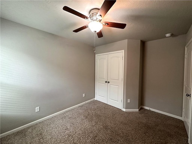 unfurnished bedroom with a ceiling fan, carpet, baseboards, and a closet