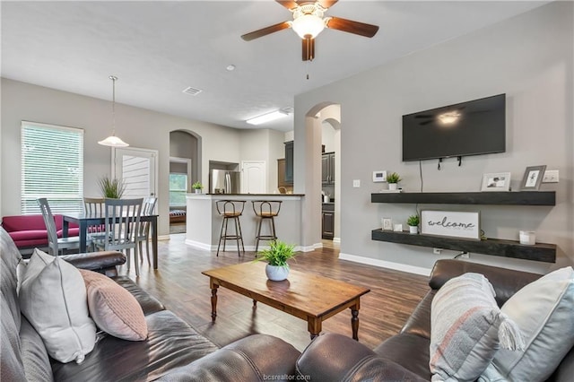 living room featuring ceiling fan and hardwood / wood-style floors