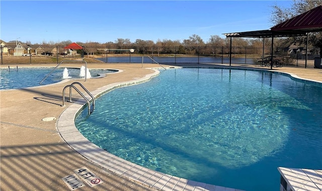 pool featuring a patio area and fence