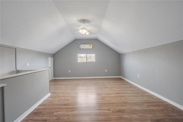 bonus room with vaulted ceiling and light hardwood / wood-style floors