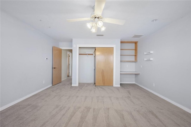 unfurnished bedroom featuring light colored carpet, a closet, and ceiling fan