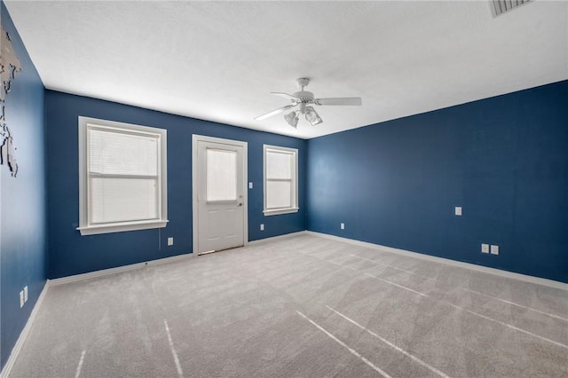 carpeted empty room with ceiling fan