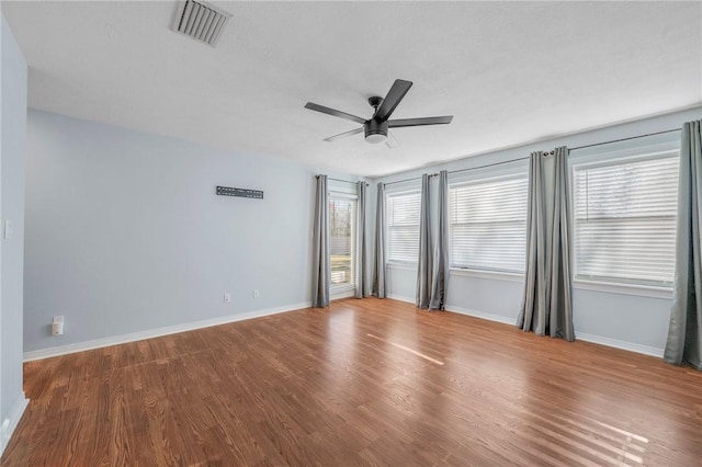 unfurnished room with wood-type flooring and ceiling fan