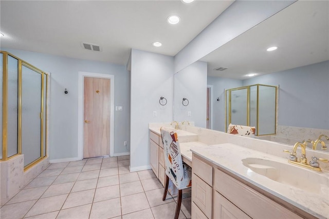 bathroom with tile patterned flooring, vanity, and a shower with door