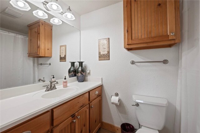 full bath with toilet and vanity