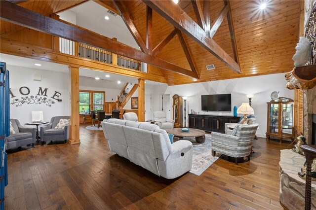 living area featuring high vaulted ceiling, beam ceiling, hardwood / wood-style flooring, and visible vents