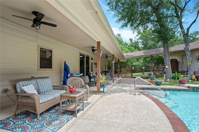 outdoor pool featuring outdoor lounge area, fence, a ceiling fan, and a patio area