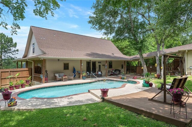 view of pool with a fenced in pool, a deck, a patio area, and a fenced backyard