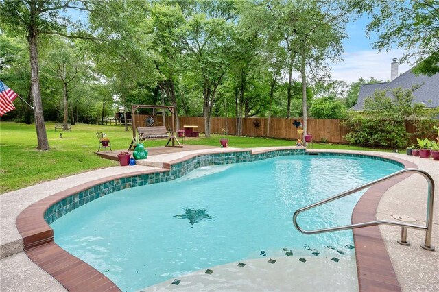 view of swimming pool featuring a yard, a fenced in pool, and a fenced backyard