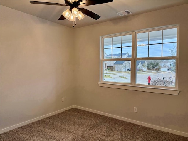 empty room featuring carpet and ceiling fan