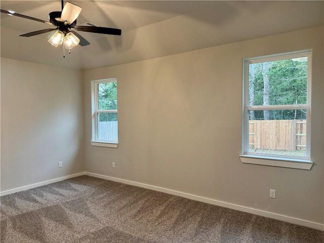 unfurnished room featuring ceiling fan, plenty of natural light, carpet floors, and vaulted ceiling