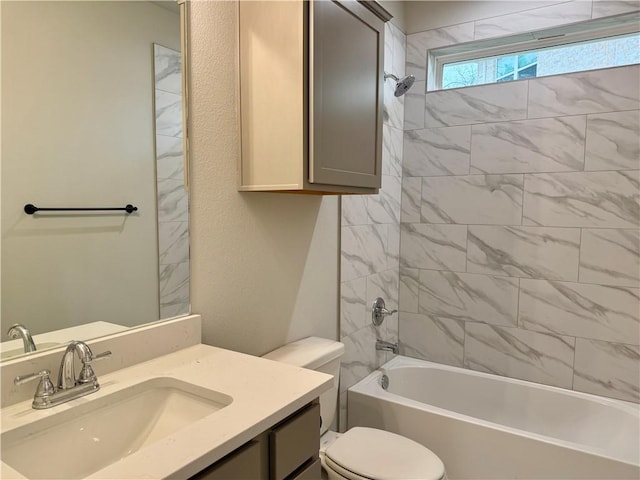 full bathroom with toilet, vanity, and tiled shower / bath