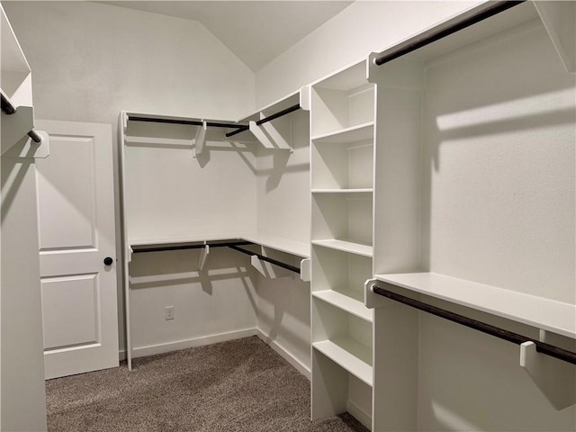 spacious closet with vaulted ceiling and dark carpet