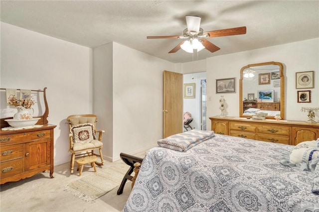 bedroom with ceiling fan and light carpet