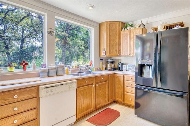 kitchen with stainless steel fridge, dishwasher, and sink