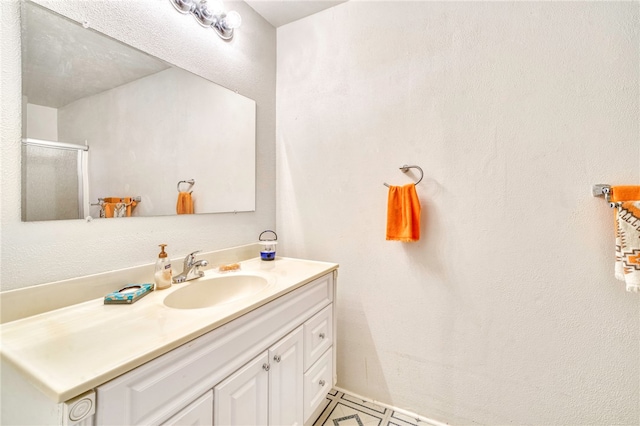 bathroom featuring tile patterned flooring, vanity, and an enclosed shower