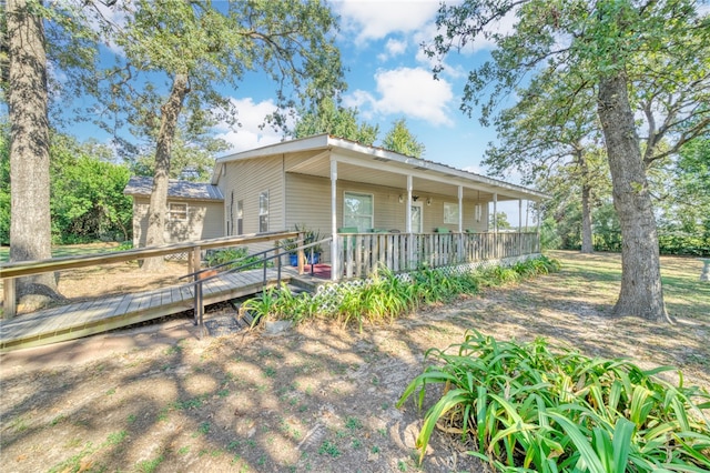 rear view of house featuring a wooden deck