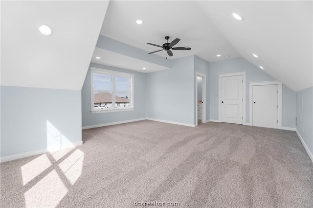 bonus room featuring ceiling fan, light carpet, and vaulted ceiling